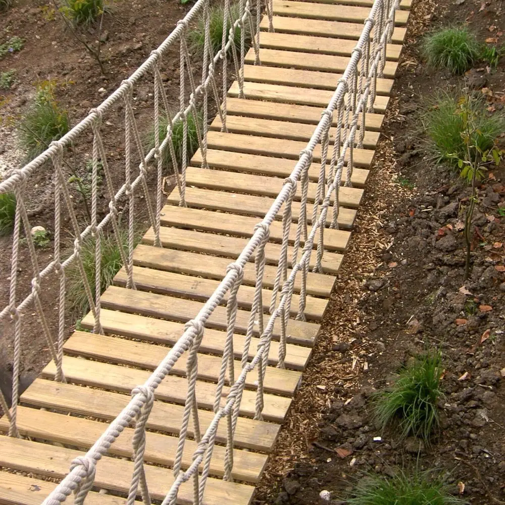 Long Rope Bridge in landscaped garden leading to a kids Treehouse.