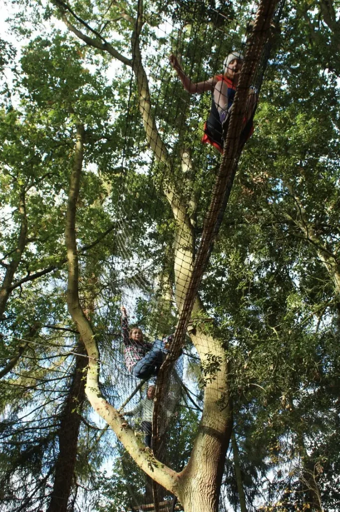 Girl in a Treetop Walkway high above the ground between trees
