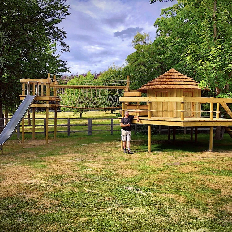Thatched roof Treehouse with multiple Deck Platforms, Rope Bridge and Slide.
