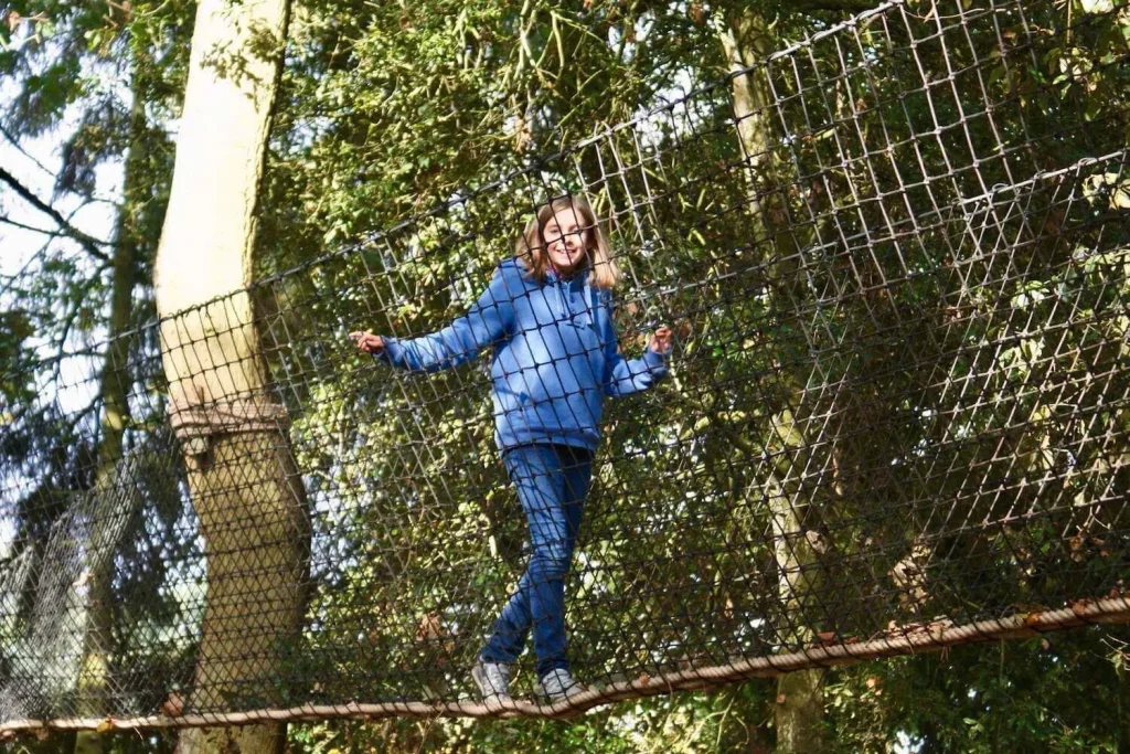 Girl walking in Treetop Walkway Rope Bridge